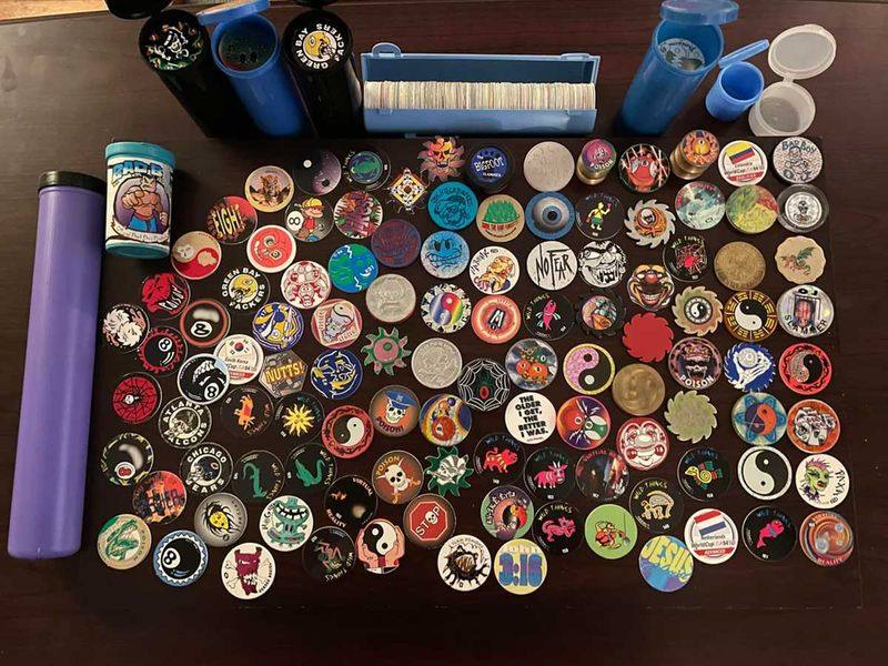 Pogs 90s massive personal collection spread across a table with plastic tubes