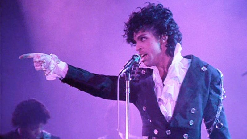 Prince points to the crowd performing in the Purple Rain movie