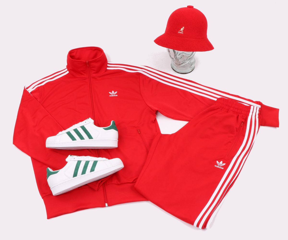 Iconic 90s hip-hop fashion: Adidas tracksuit, Kangol bucket hat, and Superstar sneakers