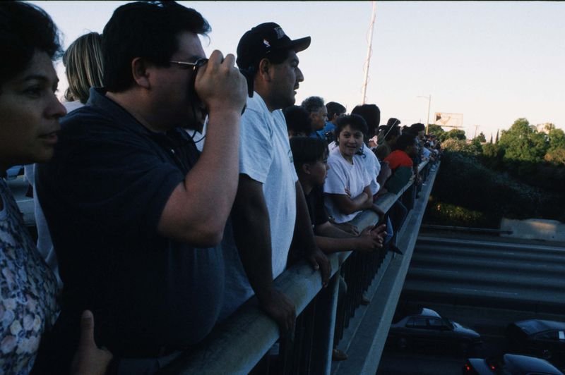 Spectators watching the OJ Simpson Bronco chase from a 405 freeway overpass in Los Angeles