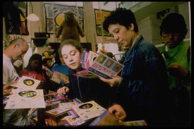 Tamagotchi 90s craze: shoppers crowd a US toy-store launch display in 1997