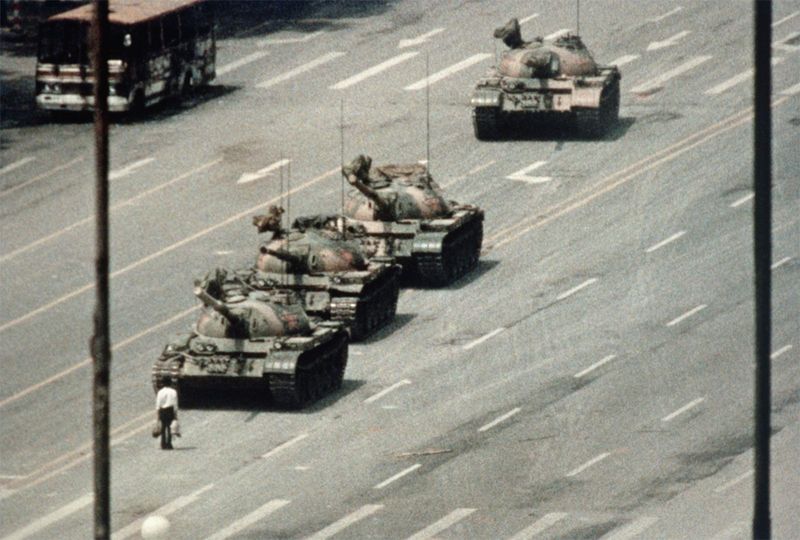 Wide shot Tank Man facing column of four tanks Chang an Avenue June 5 1989