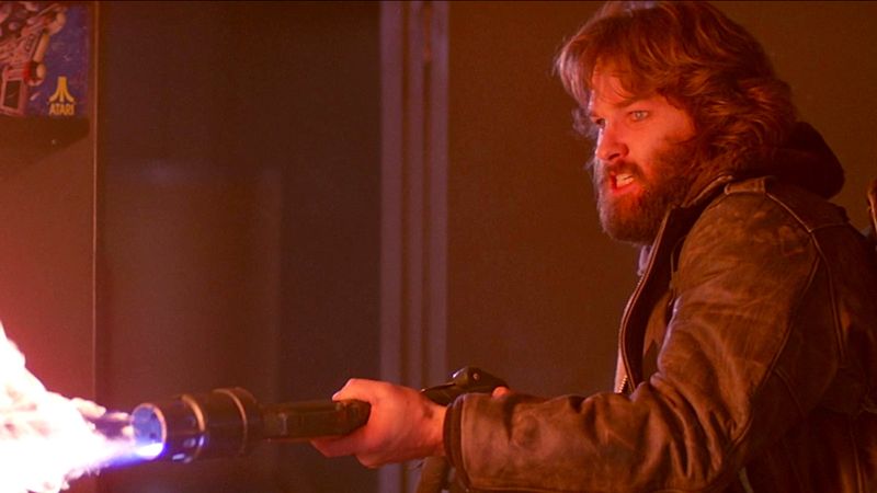 Kurt Russell as MacReady firing a flamethrower in The Thing 1982