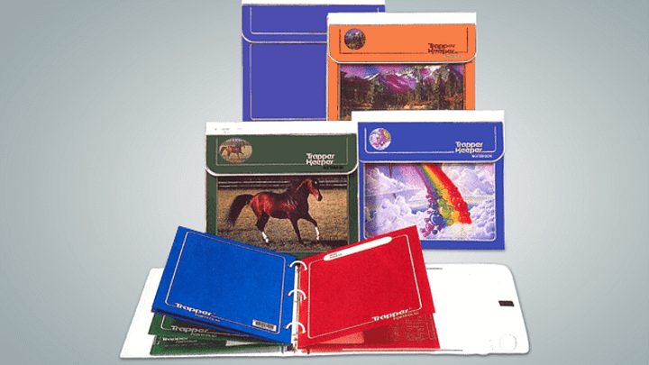 Open Trapper Keeper Mead binder showing colorful Trapper folders inside with elastic flap