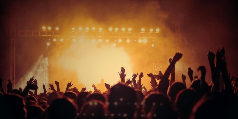 concert crowd at a rock show where original vintage band tees were sold