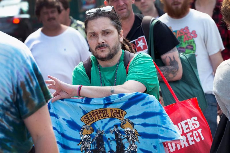 concert fan displaying a vintage 1980s Grateful Dead skeleton band t-shirt