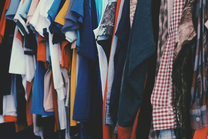 rack of vintage band tees hanging at a thrift store