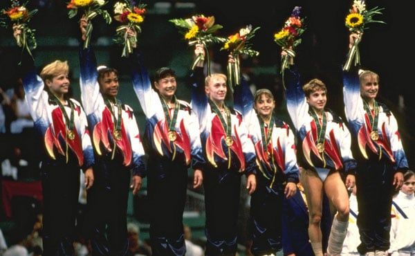 Team USA Magnificent Seven with gold medals and flowers at the 1996 Atlanta Olympics medal ceremony
