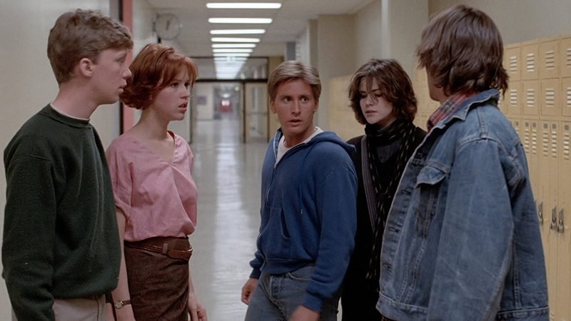 The Breakfast Club cast gathered in school hallway beside lockers