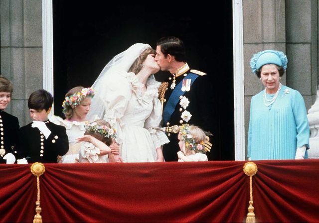 Prince Charles and Princess Diana kiss on the Buckingham Palace balcony as Queen Elizabeth looks on at the 1981 Royal Wedding