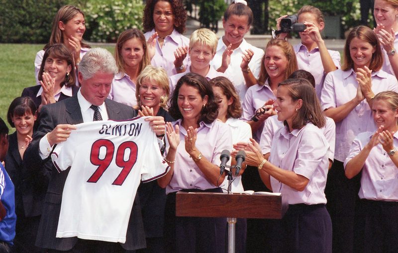 President Clinton holding a CLINTON 99 US Womens World Cup jersey