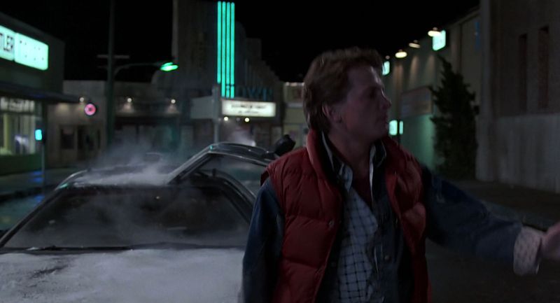 Marty McFly beside the DeLorean fire trails in Back to the Future finale