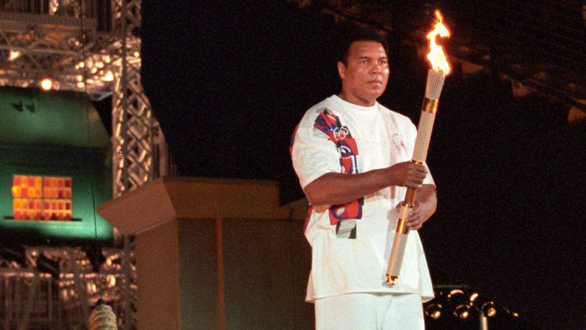 Muhammad Ali holds the Olympic torch at the Atlanta 1996 opening ceremony on July 19