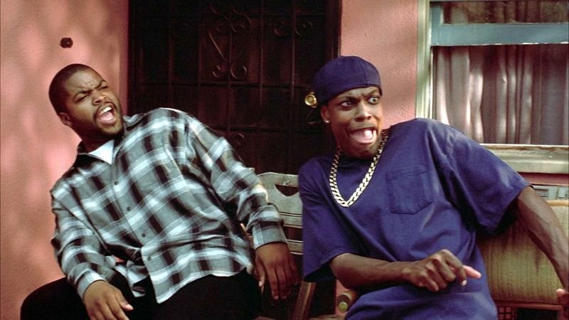 Ice Cube and Chris Tucker laughing on the porch in Friday 1995