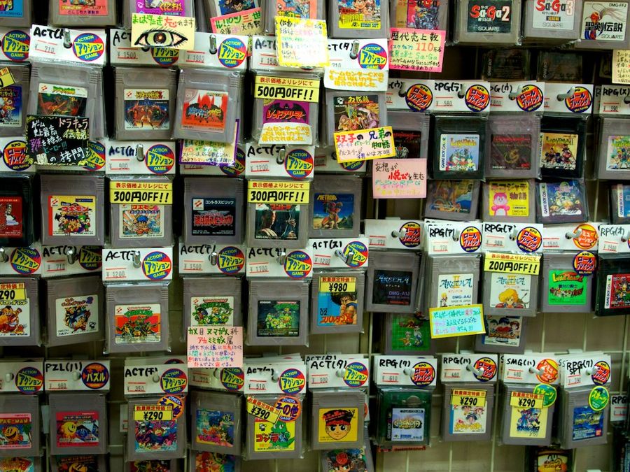 Collection of Nintendo Game Boy game cartridges displayed on a shop wall