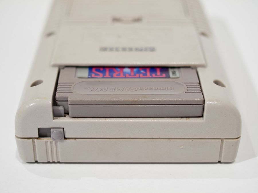 Nintendo Game Boy with a Tetris game cartridge inserted into the classic grey handheld