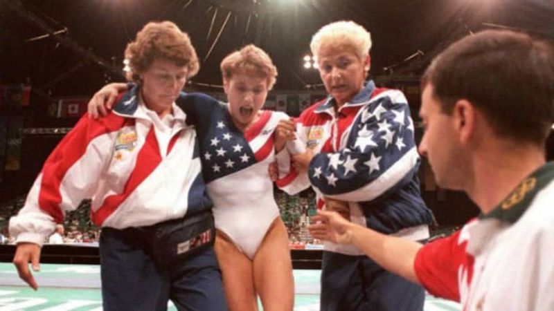 Kerri Strug screaming in pain being helped off the floor at the 1996 Olympics after ankle injury