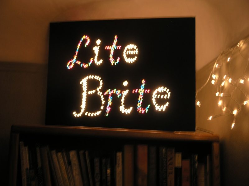 Lite-Brite logo spelled in glowing pegs on the classic black panel