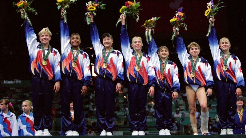 The Magnificent Seven on the victory podium at the 1996 Atlanta Olympics with gold medals