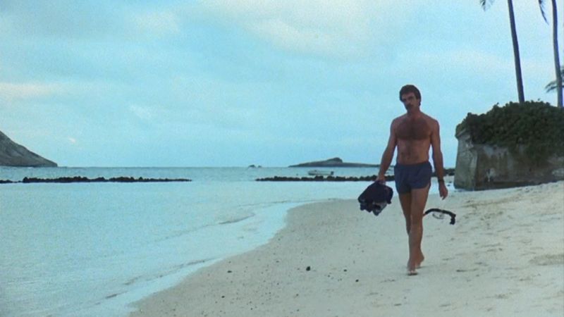 Tom Selleck Magnum PI walking on Hawaii beach with snorkeling gear