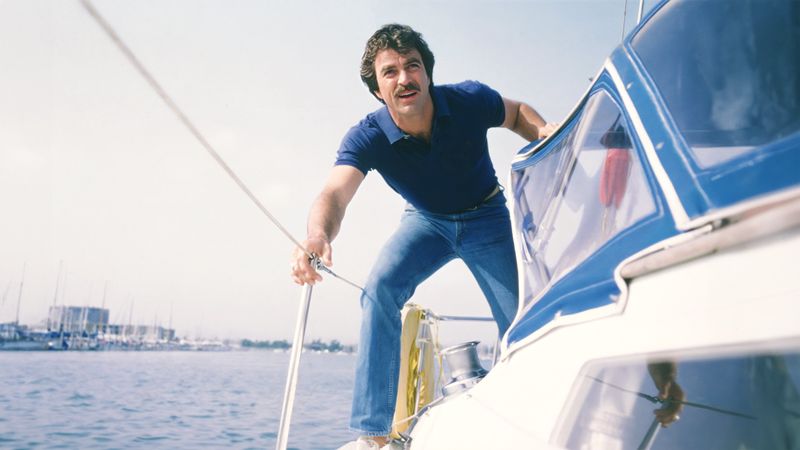 Tom Selleck Magnum PI on sailboat in Hawaii harbor