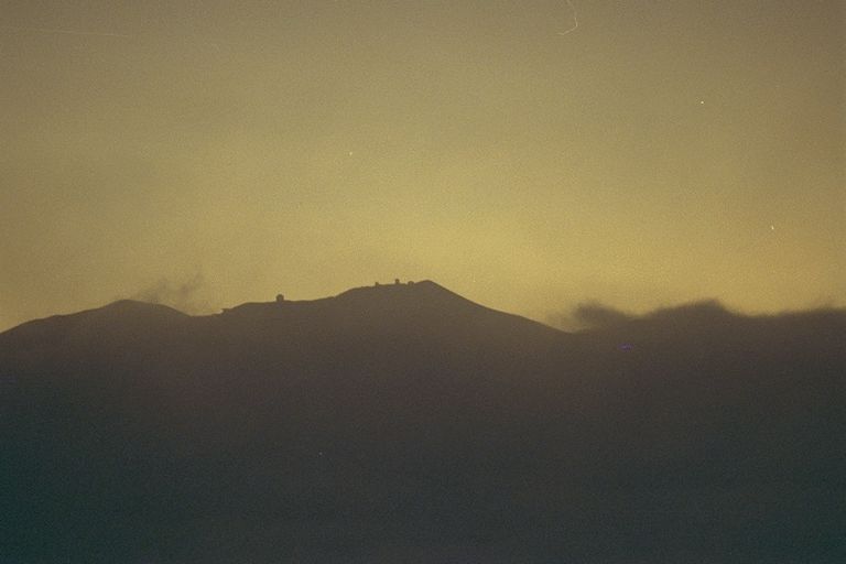 Mauna Kea observatory domes silhouetted during totality of the 1991 eclipse