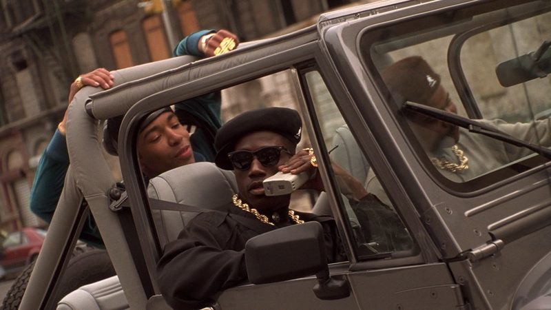 New Jack City Nino Brown on a brick cell phone in a jeep