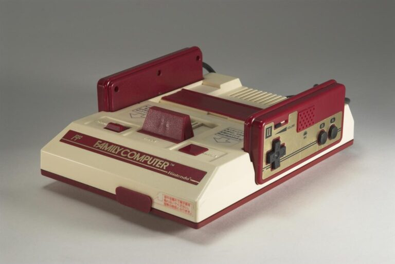 Nintendo Famicom console from 1983 with its red and white design and hardwired controllers