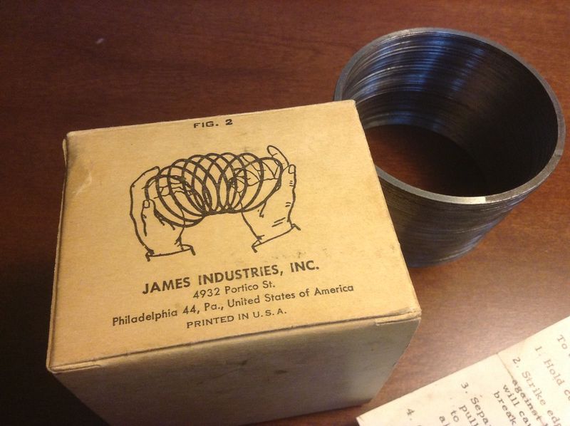 Original metal Slinky beside the James Industries Philadelphia box