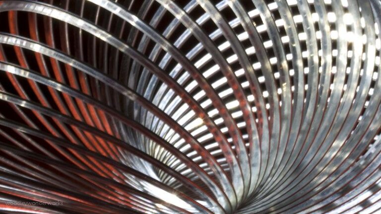 Classic metal Slinky toy coils in a close-up spiral, the original helical spring toy