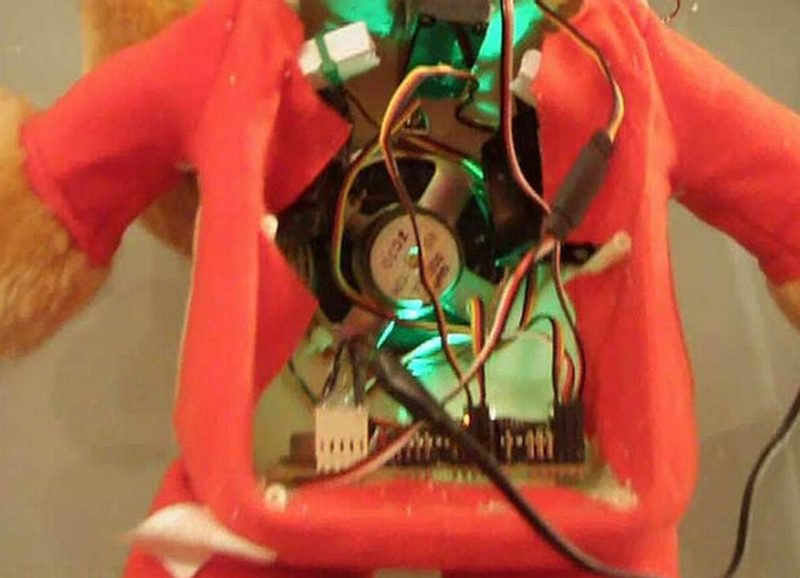 The electronics and servo motors inside a Teddy Ruxpin talking bear