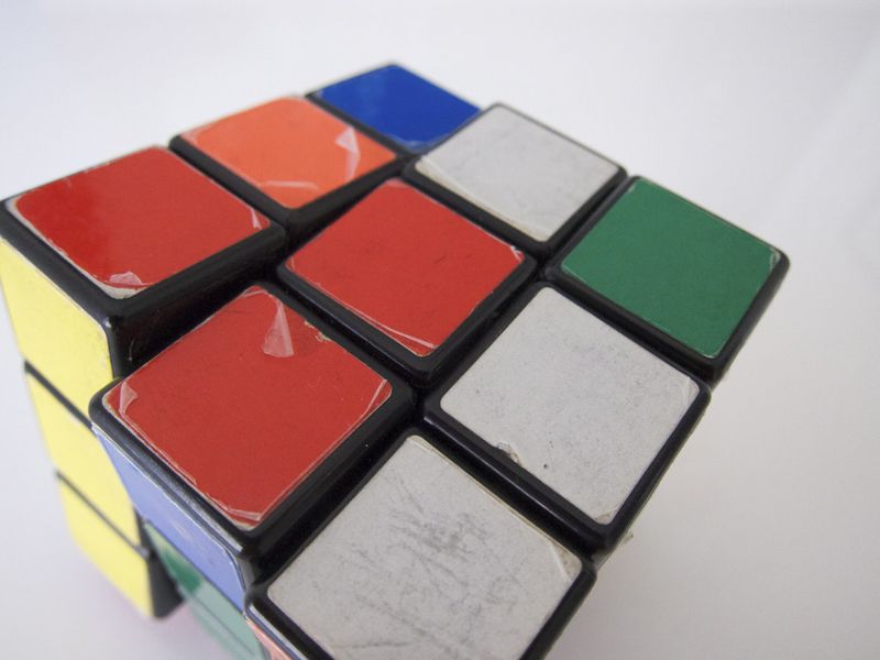 Close-up of a worn vintage Rubik's Cube with scratched stickers