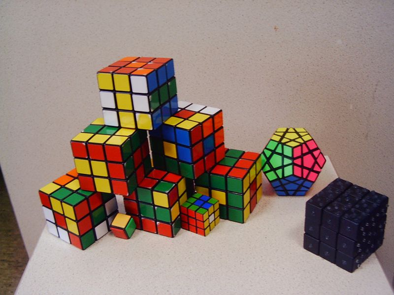 A collection of Rubik's Cube puzzles stacked together