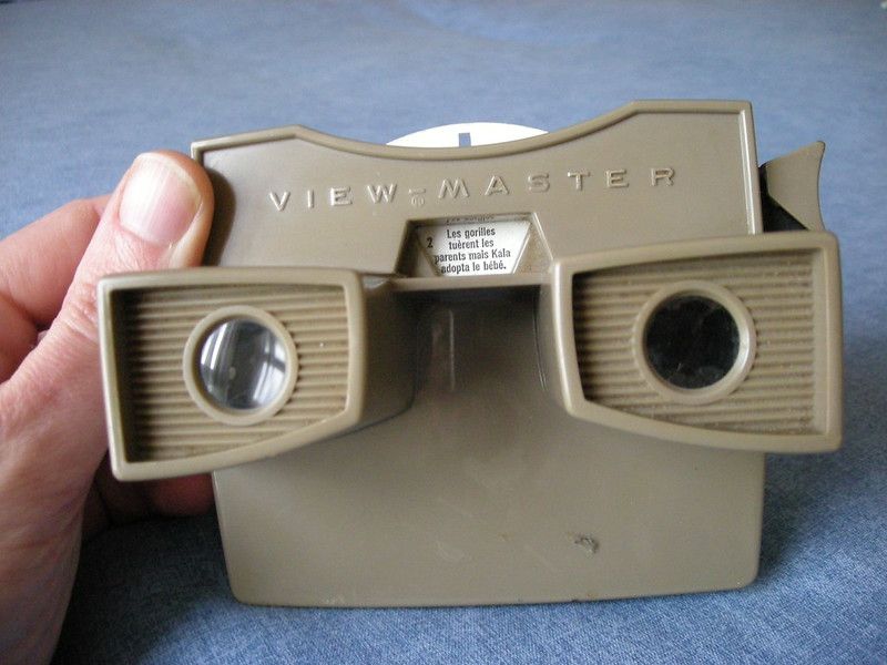 Tan View-Master viewer held in hand showing the branding