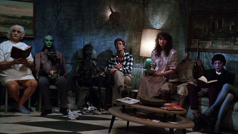 The afterlife waiting room scene in Beetlejuice 1988 with various deceased characters