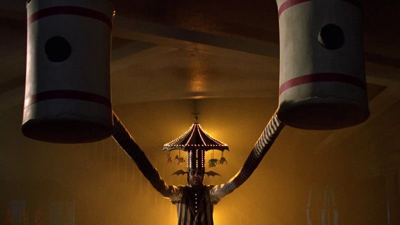 Beetlejuice 1988 iconic stretched arms scene with giant bowling pin cylinders