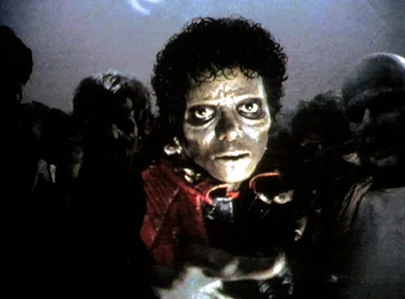 Michael Jackson as a zombie surrounded by the undead in the street dance sequence from Thriller