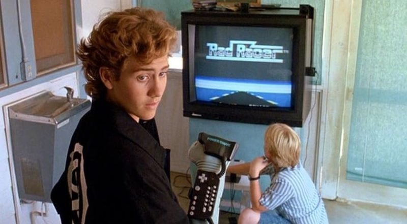 Lucas from The Wizard 1989 holding the Power Glove with Rad Racer on TV behind him