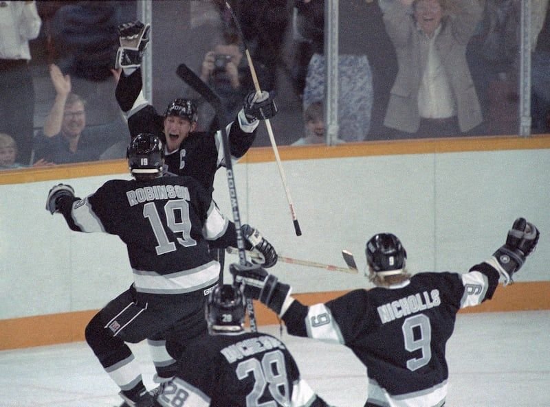 Wayne Gretzky and LA Kings teammates celebrating after breaking Gordie Howe's NHL points record in 1989