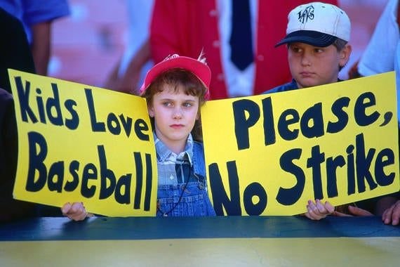 Baseball fans holding signs protesting the 1994 MLB strike and World Series cancellation