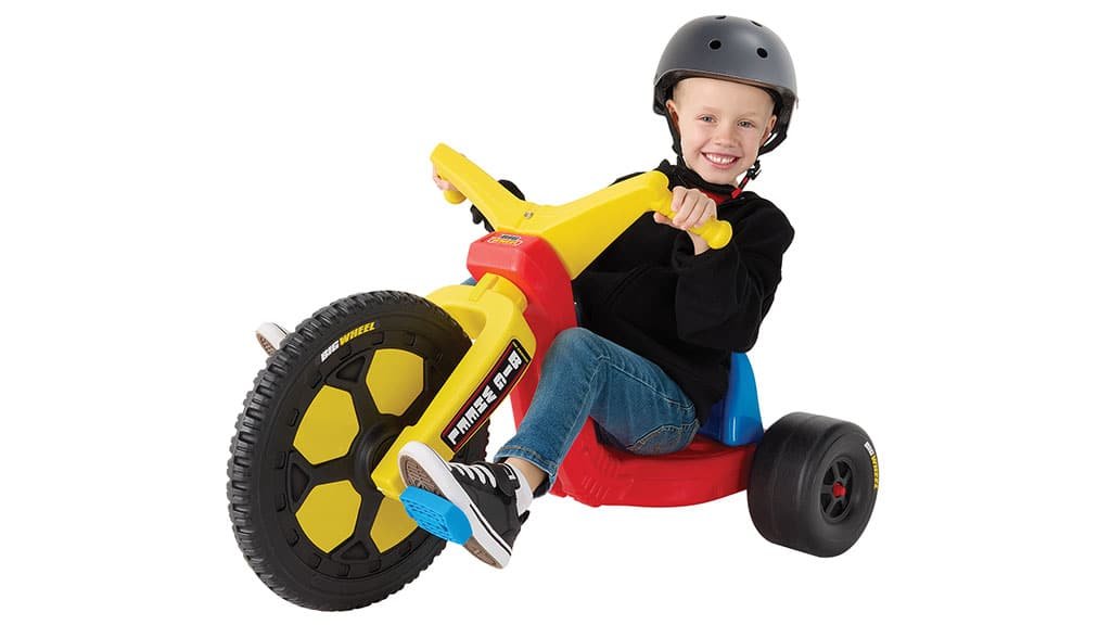 A boy wearing a helmet riding the 2026 Big Wheel Chopper model toy