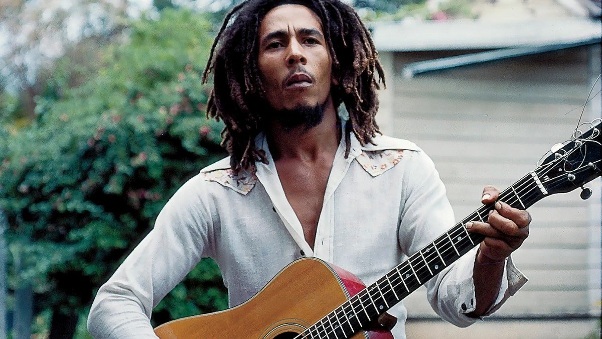 Bob Marley playing acoustic guitar in a candid 1977-era photo