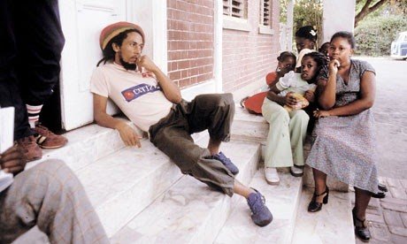 Bob Marley sitting on the porch steps at 56 Hope Road, Kingston, Jamaica