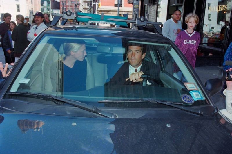 John F. Kennedy Jr. driving with Carolyn Bessette in New York City surrounded by paparazzi