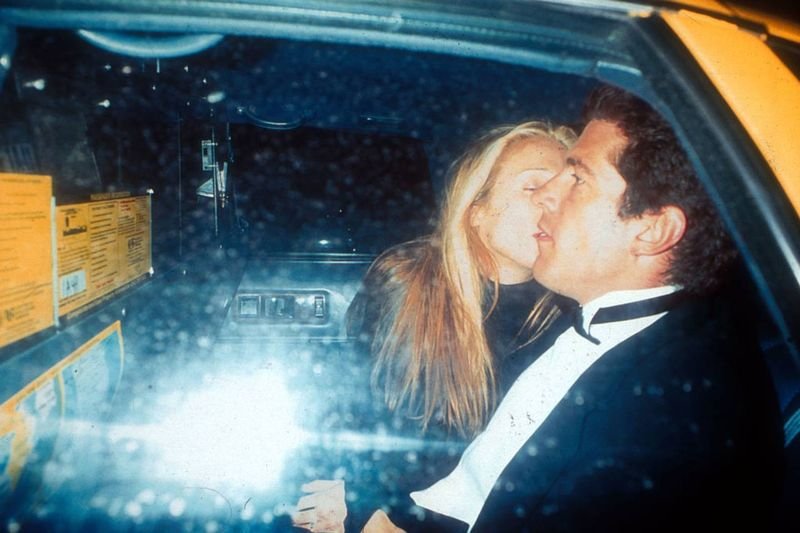 John F. Kennedy Jr. and Carolyn Bessette kissing in the back of a New York City taxi