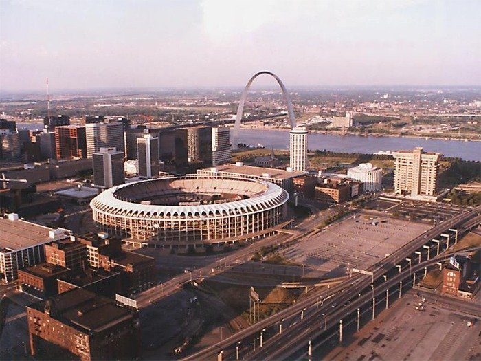 Aerial view of old Busch Stadium in downtown St. Louis with the Gateway Arch in the background