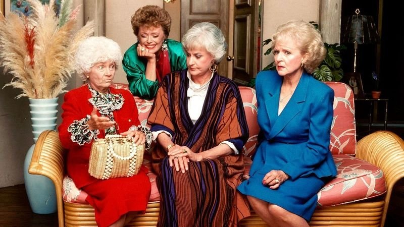 The Golden Girls cast sitting in the living room — Sophia, Blanche, Dorothy, and Rose