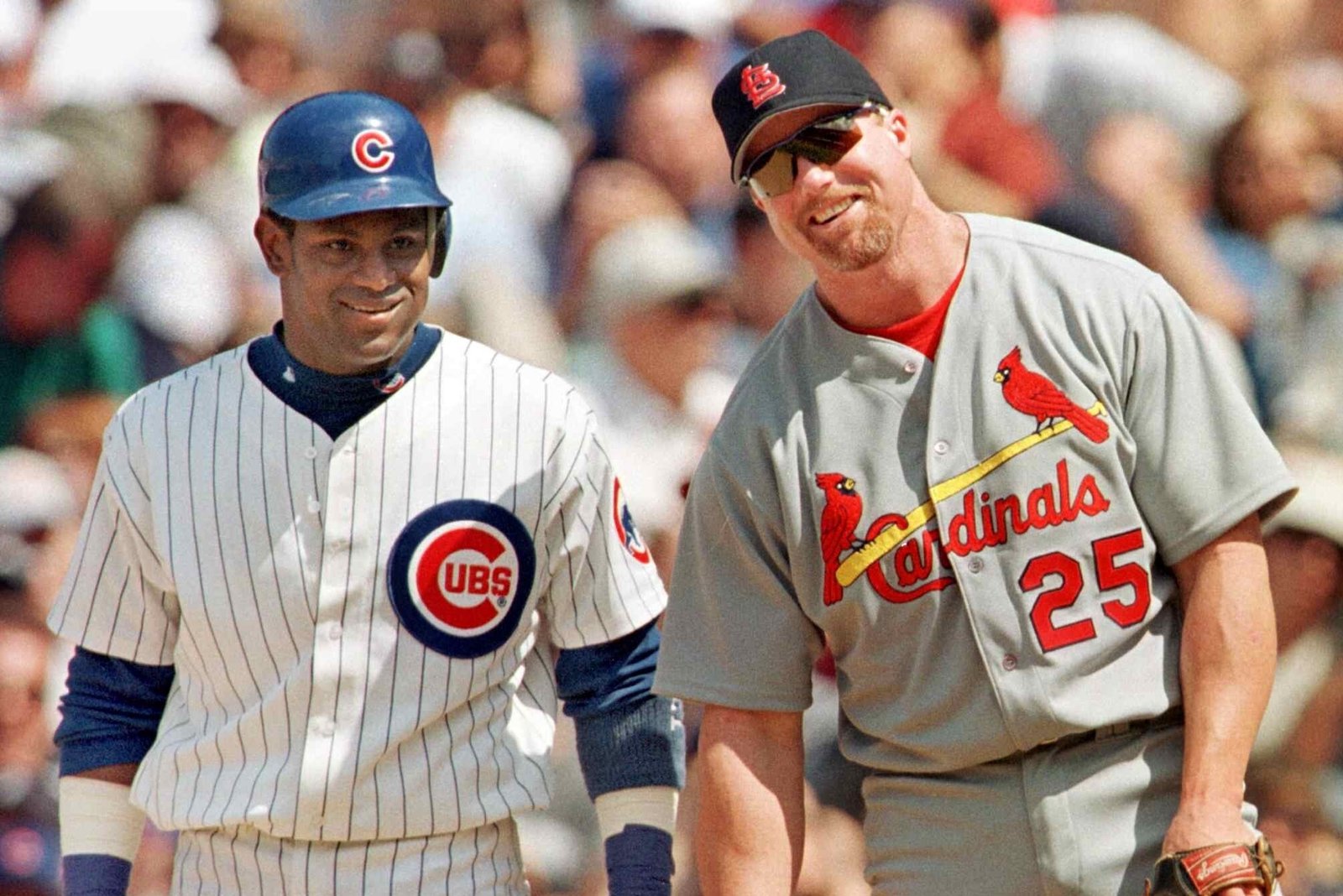 Mark McGwire and Sammy Sosa standing together on the field smiling during their 1998 home run chase