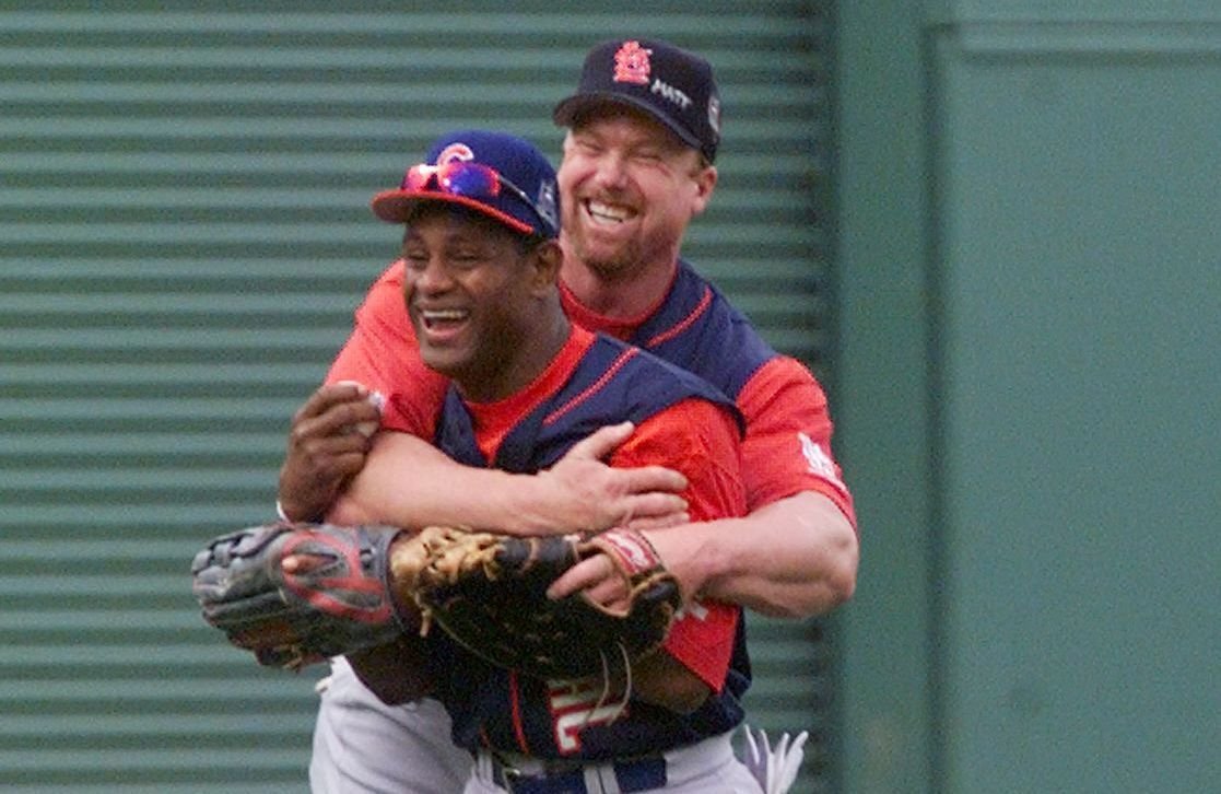 Sammy Sosa hugging Mark McGwire from behind on the field during the 1998 season