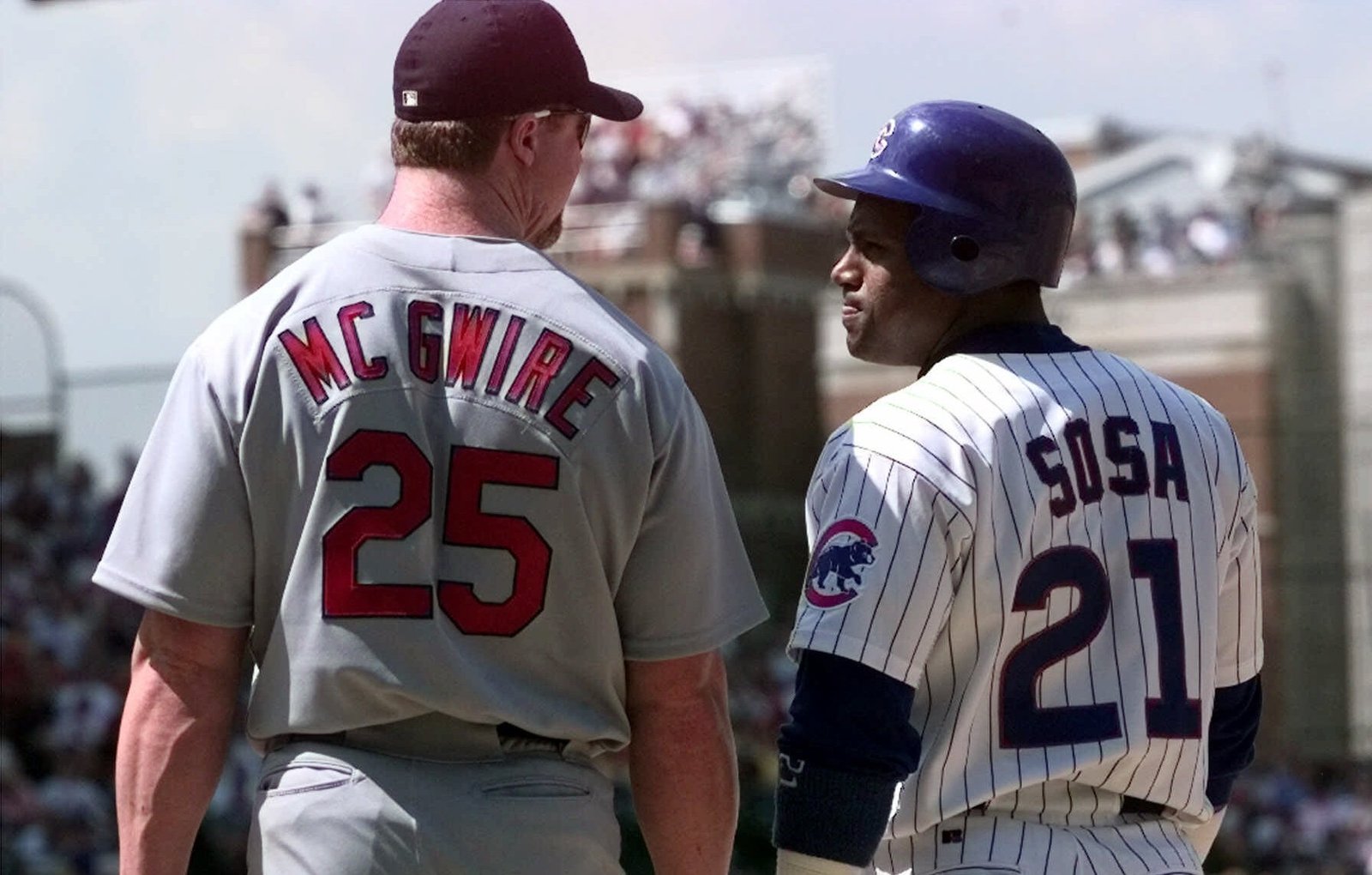 Mark McGwire and Sammy Sosa jerseys side by side, McGwire number 25 and Sosa number 21, seen from behind